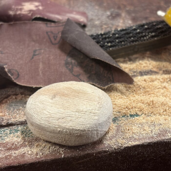 Using sanding paper to smooth the wood