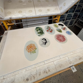 In the kiln to fire the enamels on the glass