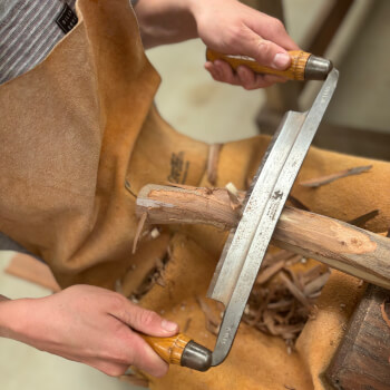 Using a drawknife on a shaving horse