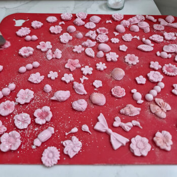 Step 4: Decorate with edible fondant flowers, pearls and gold leaf and edible lust and glitter