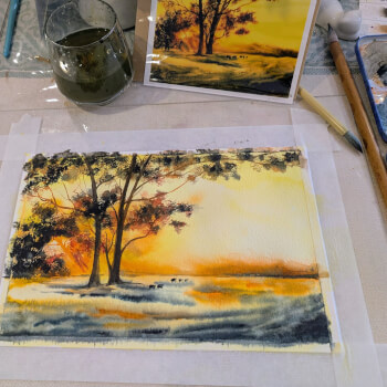 Students painting under teacher's instruction