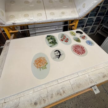 In the kiln to fire the enamels on the glass