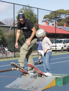 A young boy learning to drop in at a Skate Now private lesson.