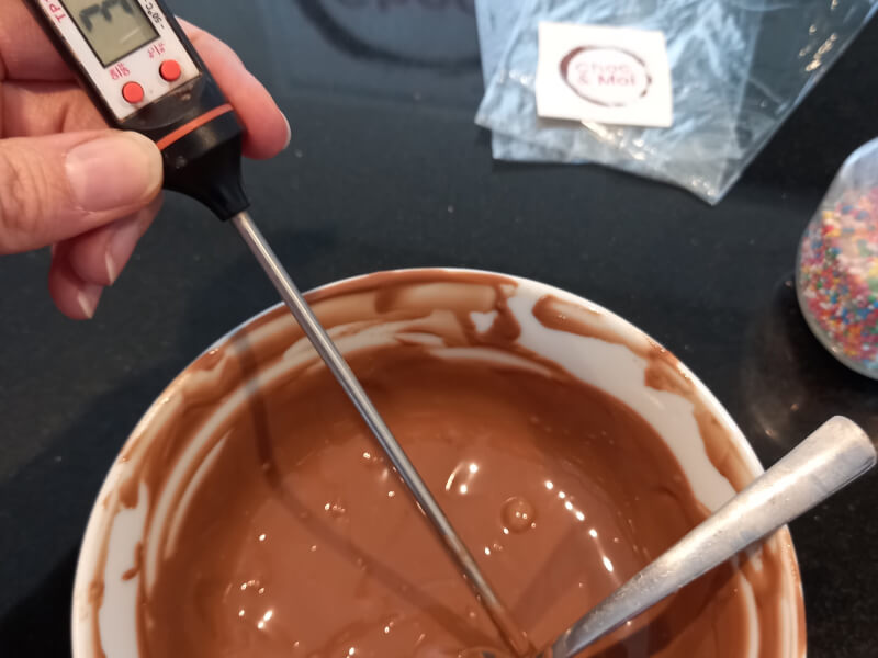 Checking the temperature of the chocolate