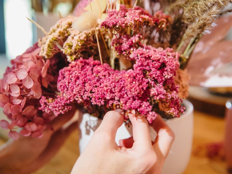 Close-up of person touching flowers