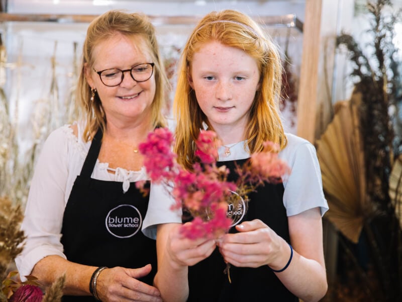 mother and daughter arranging dried flowers