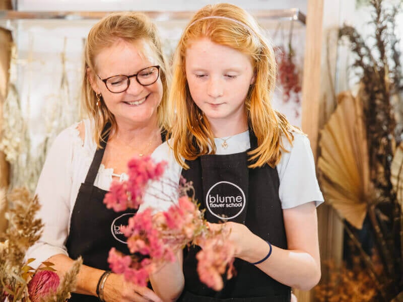Mother and daughter making a flower arrangement