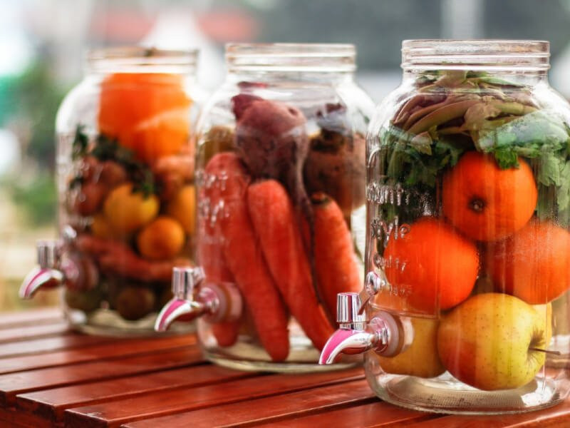Pickling jars with fruit and vegetables inside