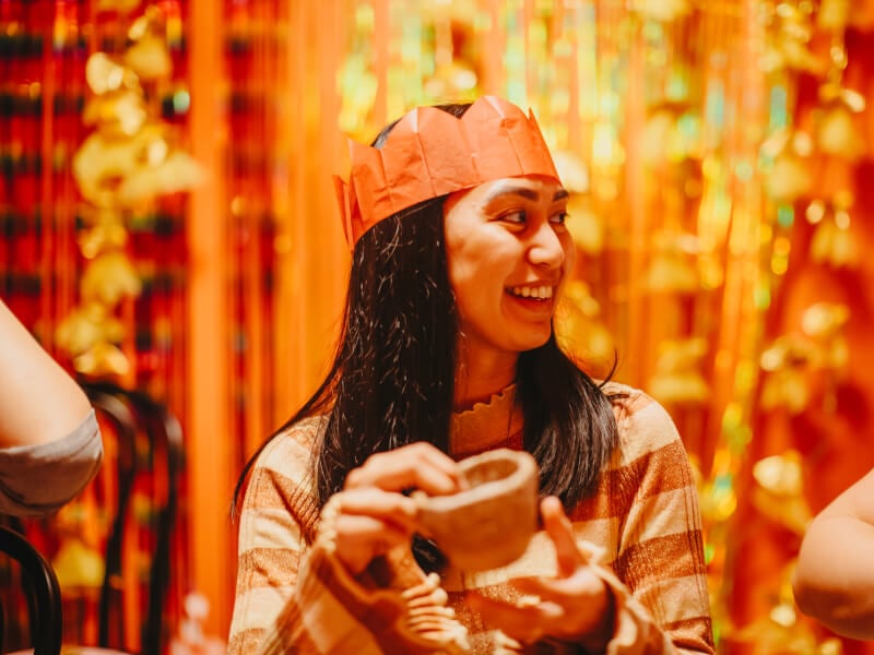 Person holding a ceramic mug at a Christmas party
