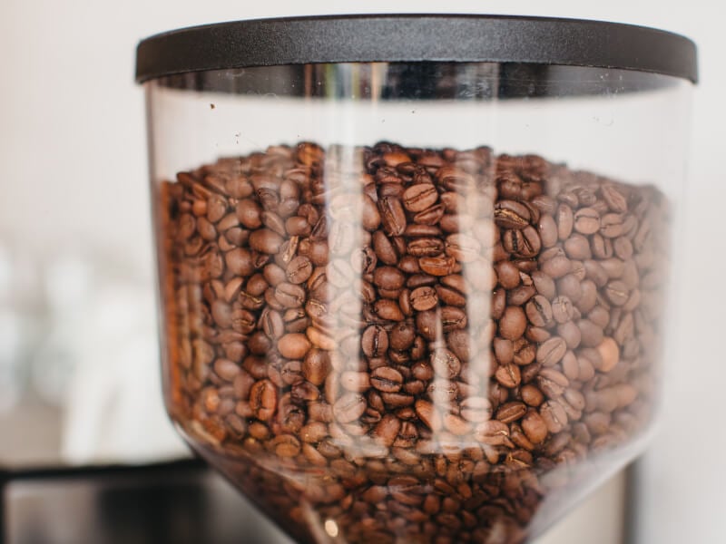 Coffee beans in a coffee grinder