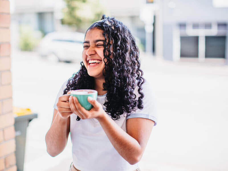 A woman laughs at her experience gift