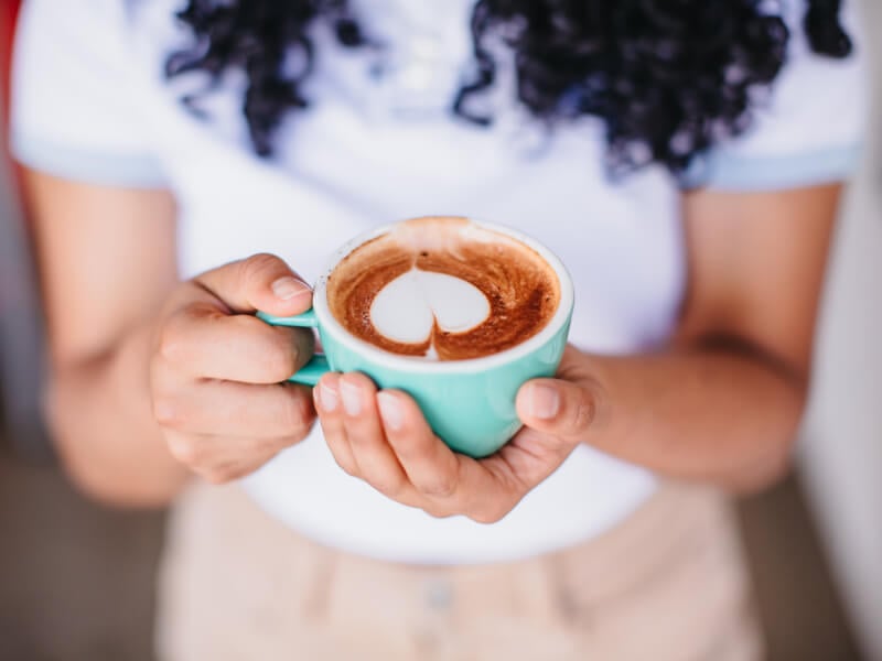 Close-up of woman holding a cup of coffee