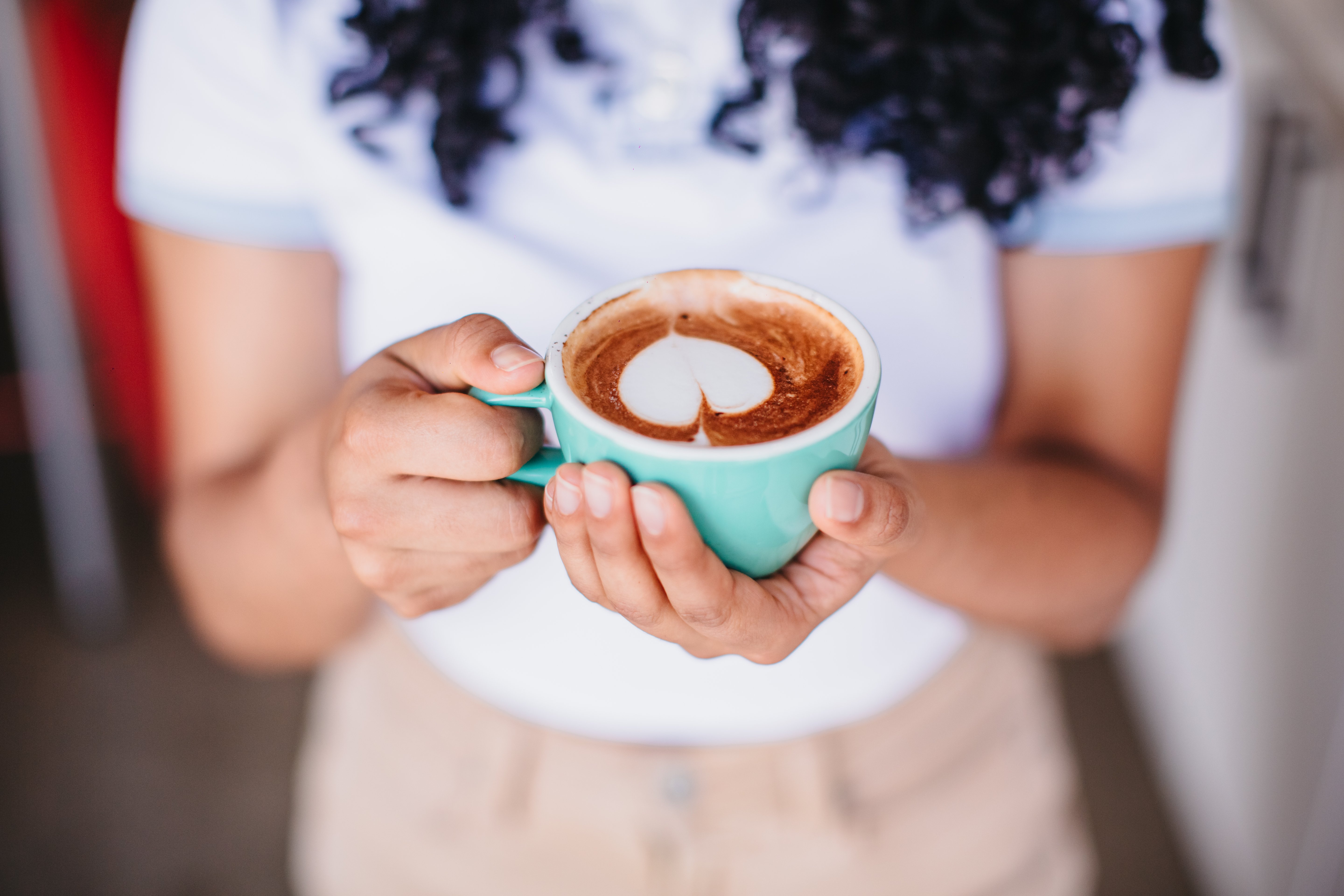 Close-up of woman holding a cup of coffee