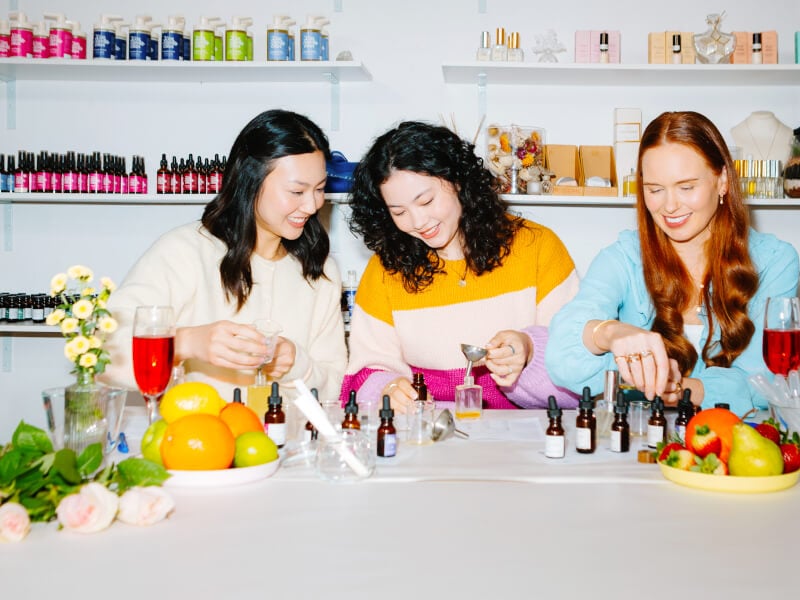 Three women making perfume side by side