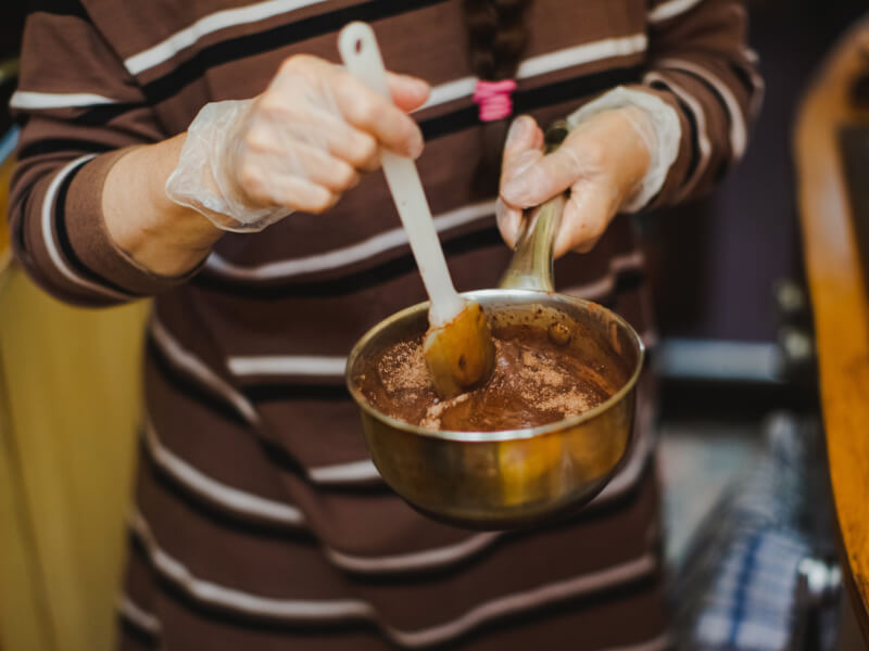 Person mixing chocolate at a chocolate making class
