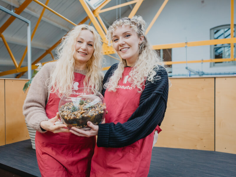 mother and daughter smiling with diy terrarium
