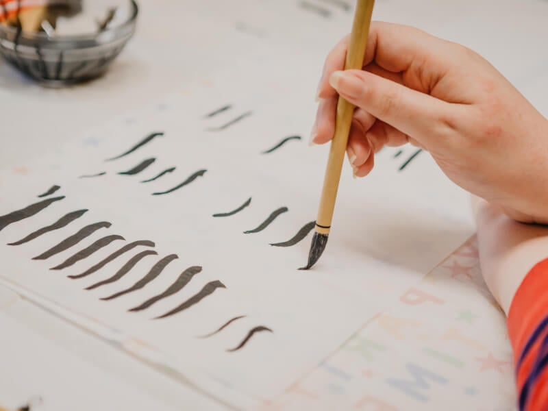 Close-up of woman practising calligraphy
