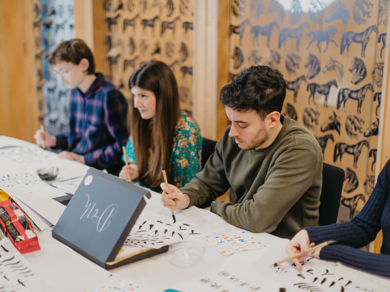 People doing calligraphy