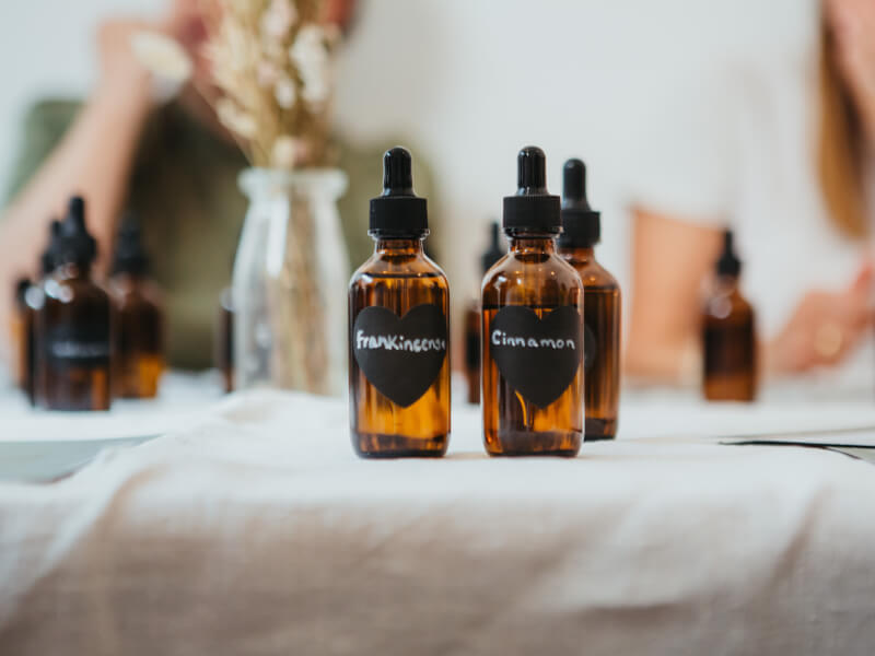Two amber dropper bottles of cinnamon and frankincense oil 