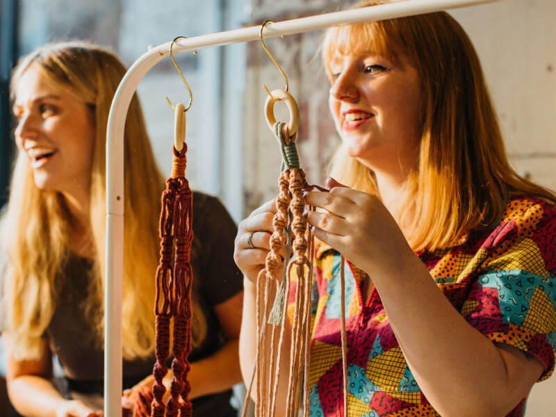 women making macrame plant hangers