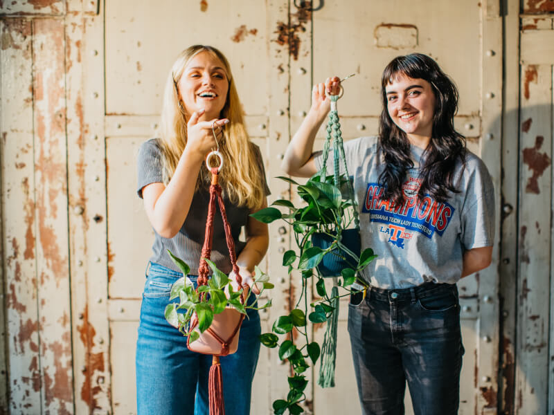 couple posing with macrame plant hangers