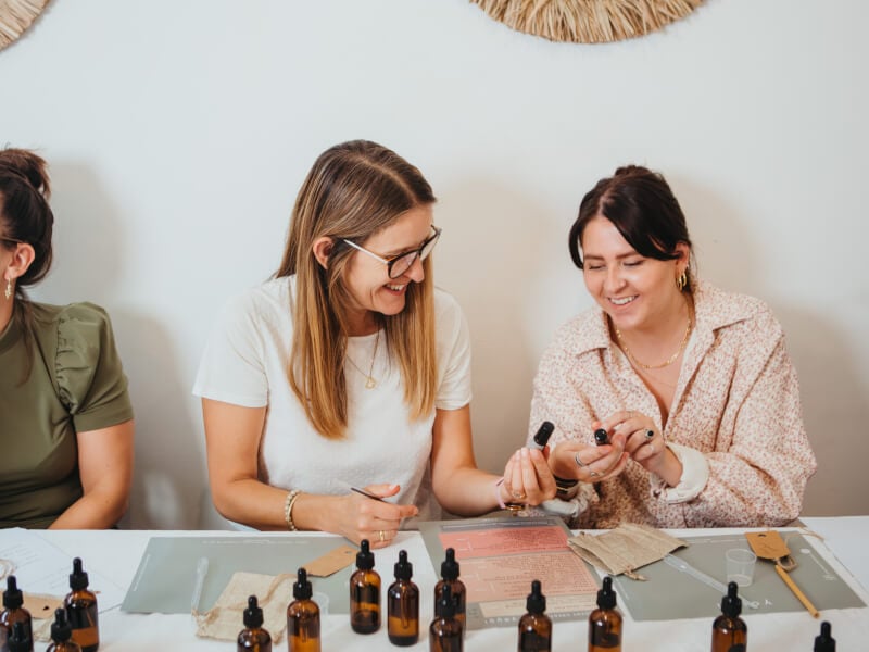 Women looking at perfume bottles