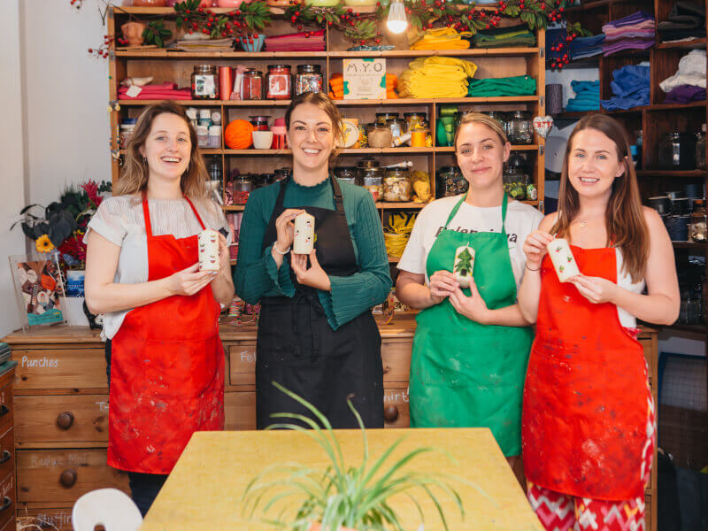 Women showing off their Christmas candles
