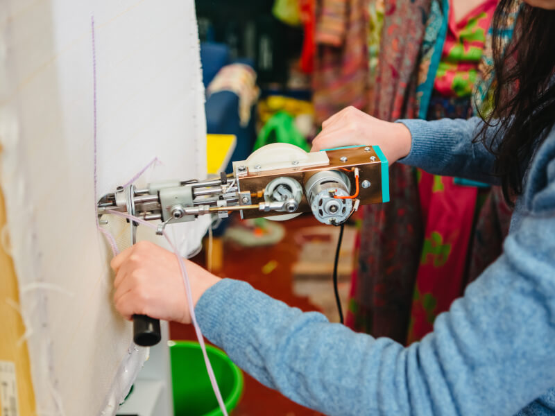 Person using a tufting gun