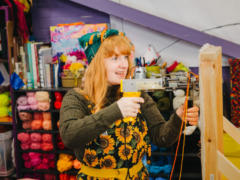 Woman using a tufting gun
