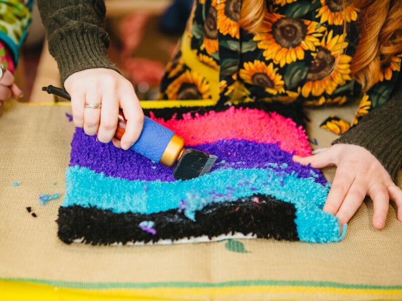 A tufted rug is being shaved 