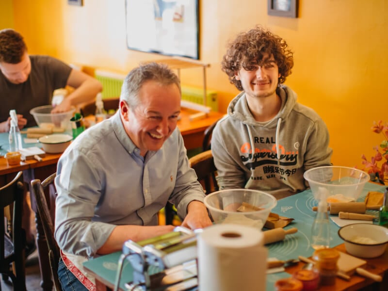 Father and son enjoying a pasta making class