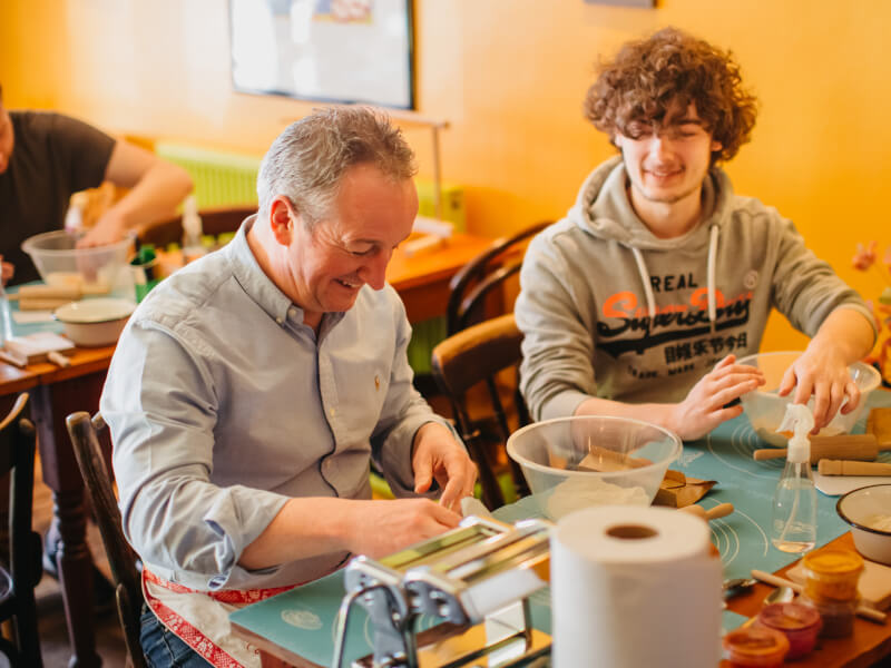 Father and daughter bonding at a pasta making class