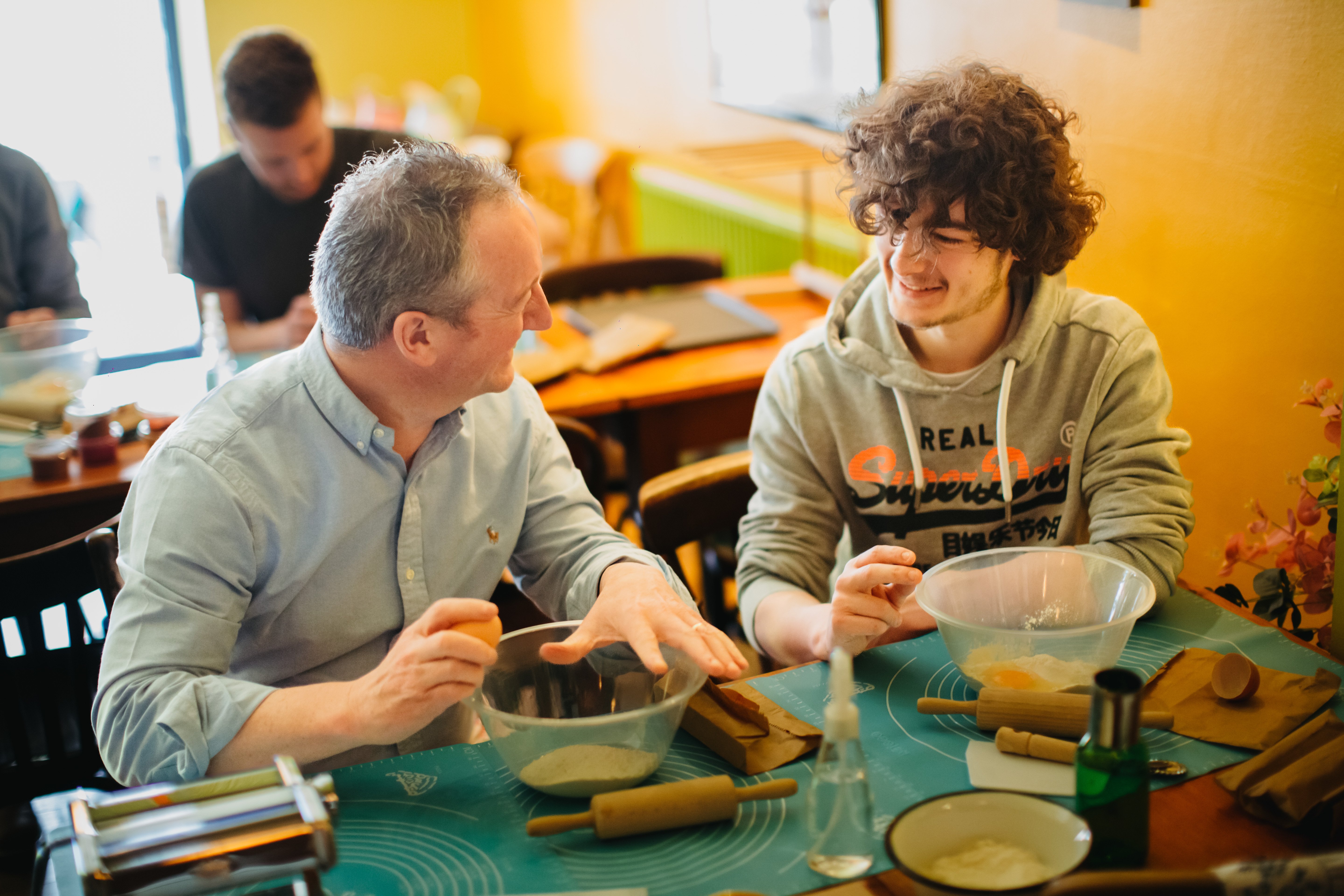 Father and son enjoying a pasta making class