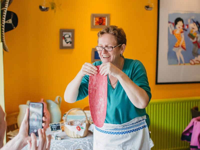 Woman holding a handmade pasta sheet