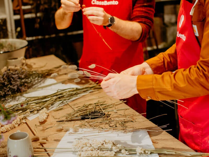 Men making dried flower arrangements