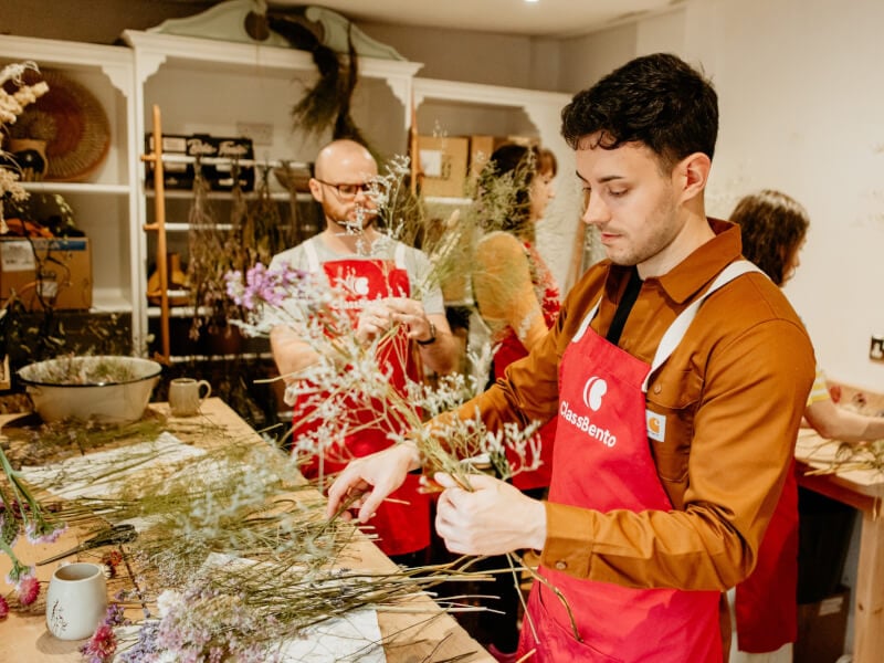 A group of friends celebrating at a floristry class
