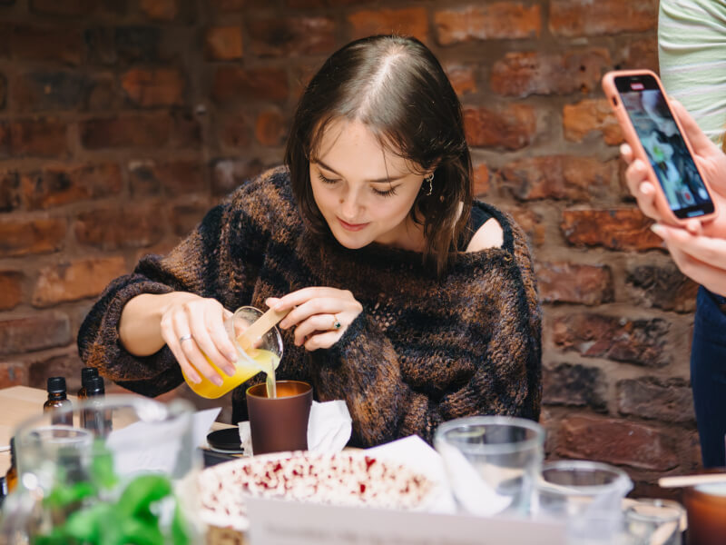 Woman pouring candle wax