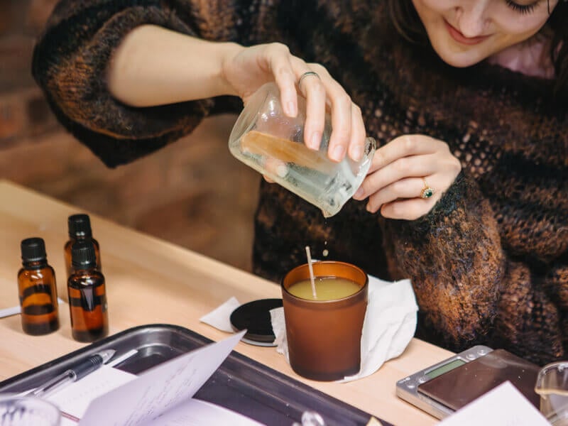 Close-up of woman pouring candle wax