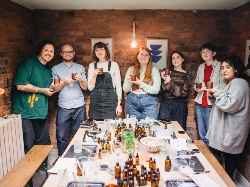 Colleagues showing off their DIY candles