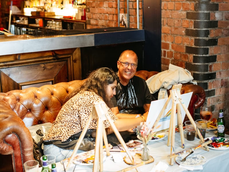 People enjoying a paint and sip class