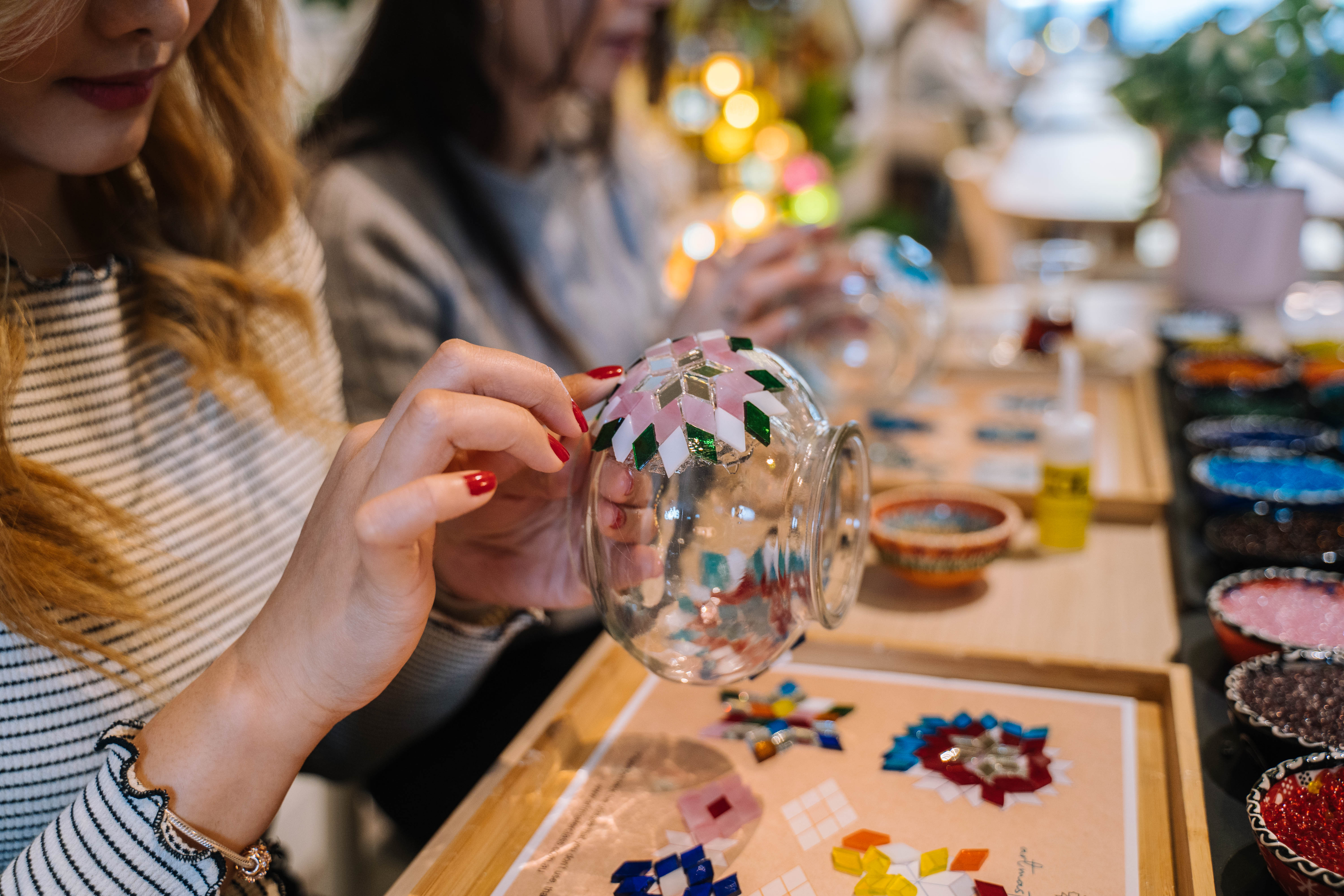 Close-up of woman making a Turkish mosaic lamp