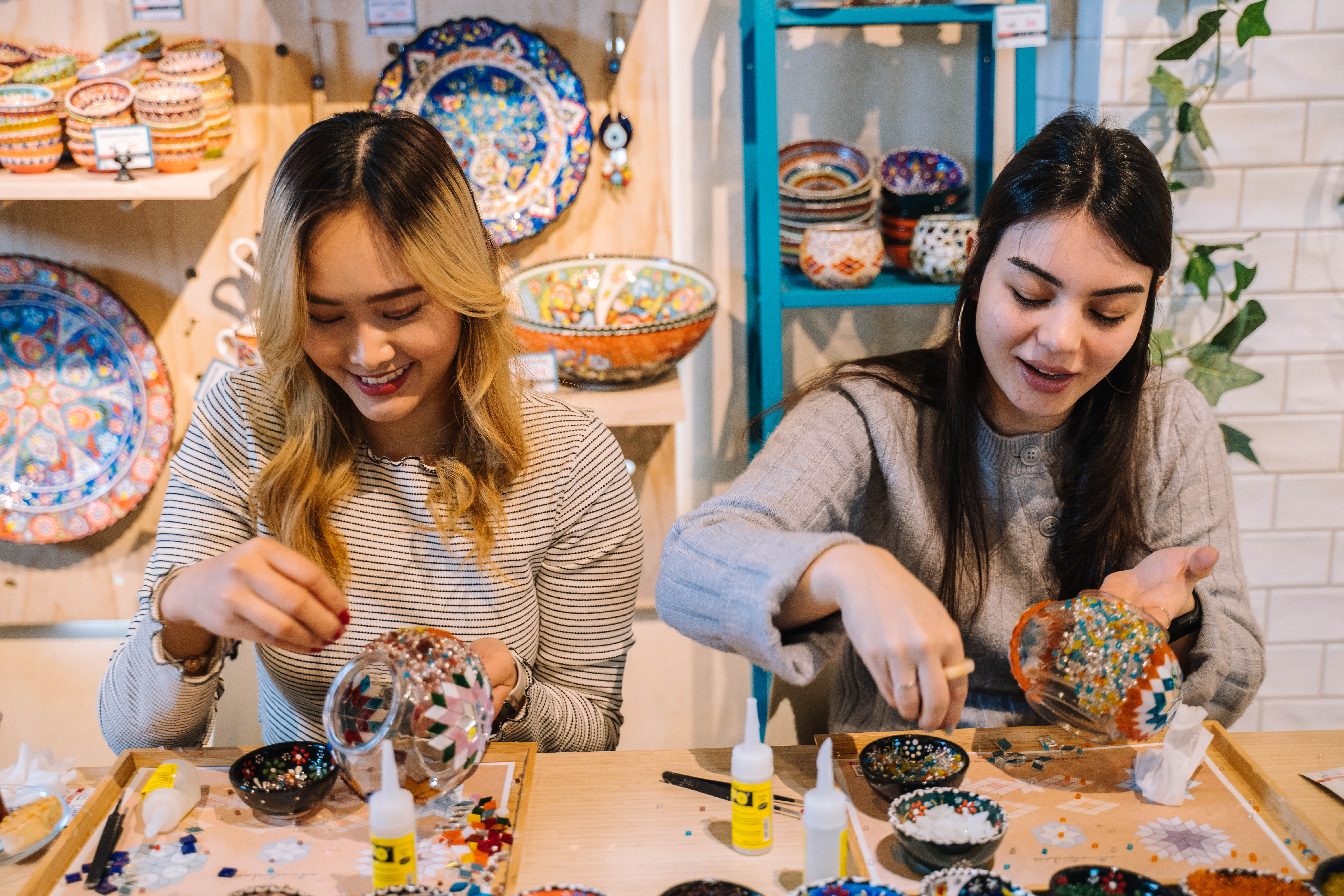 Two women making Turkish mosaic lamps