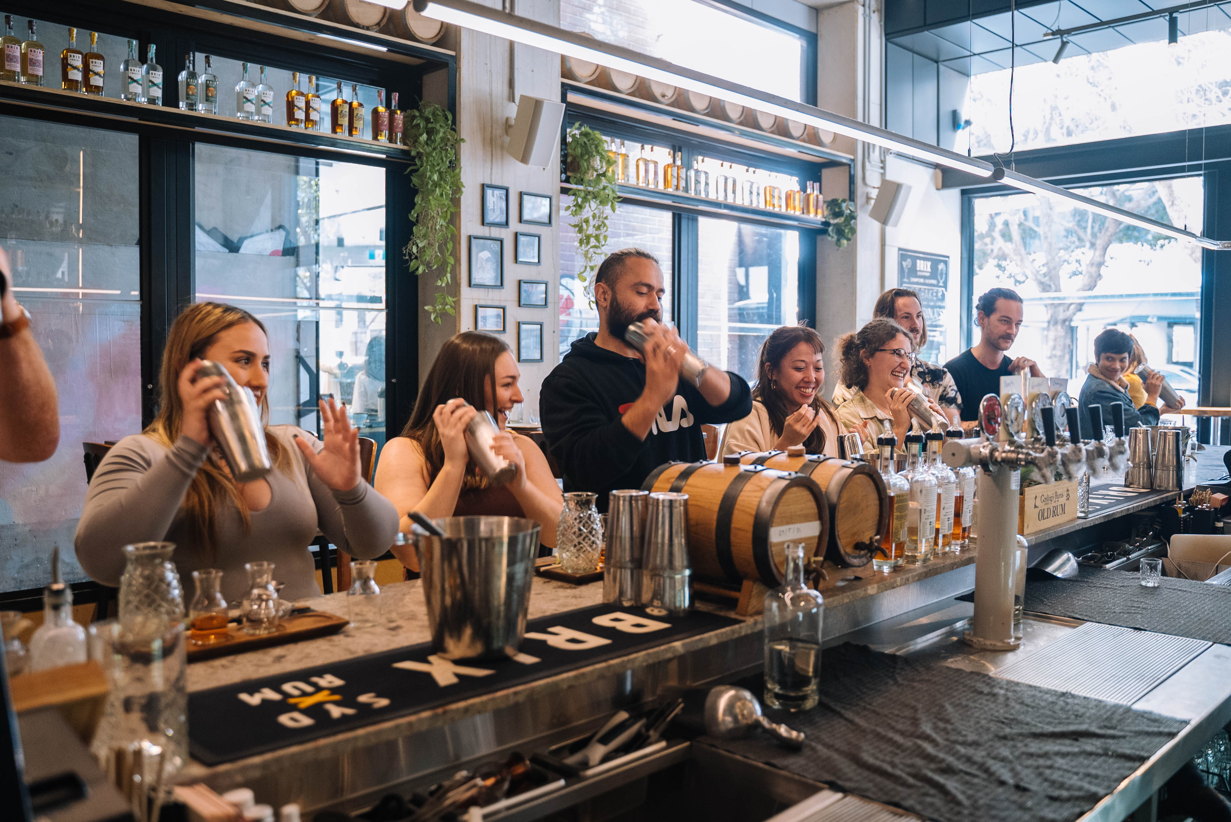 People shaking up cocktails at the bar