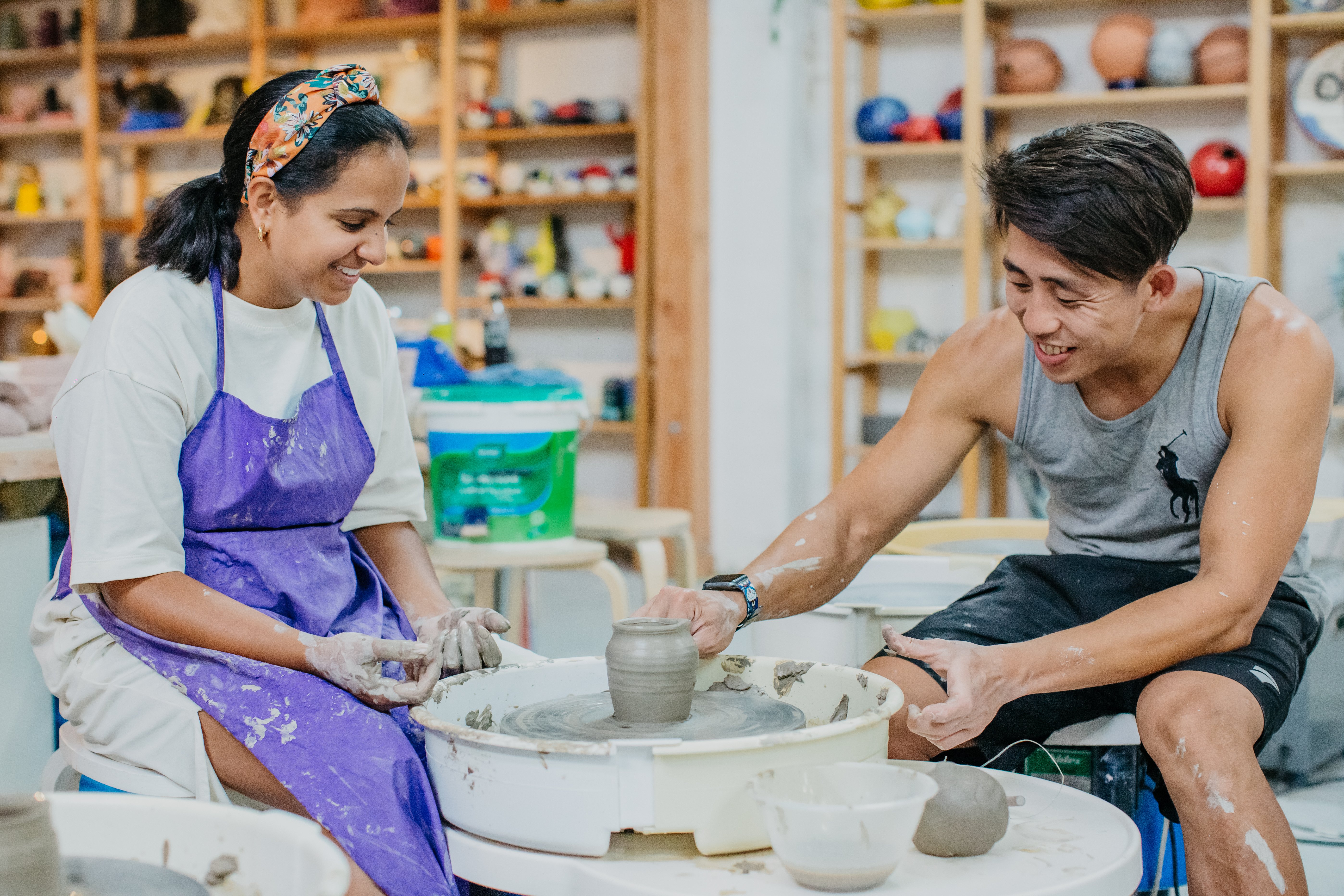 People enjoying a wheel throwing class