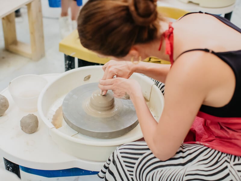 woman wheel throwing for birthday party