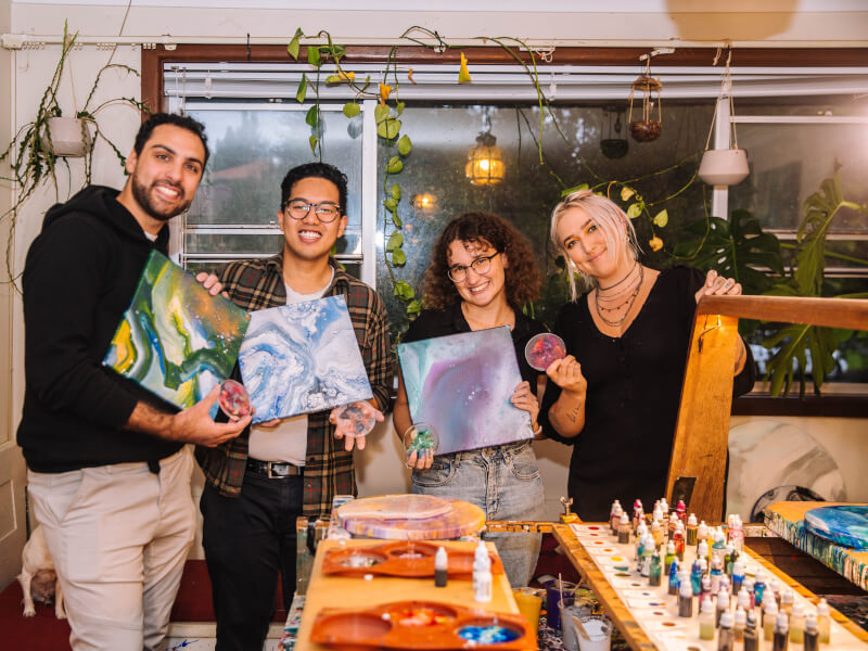 Chelsey and students posing with artworks