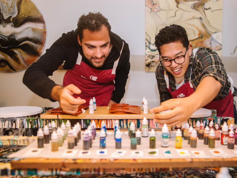 Men looking at alcohol ink bottles