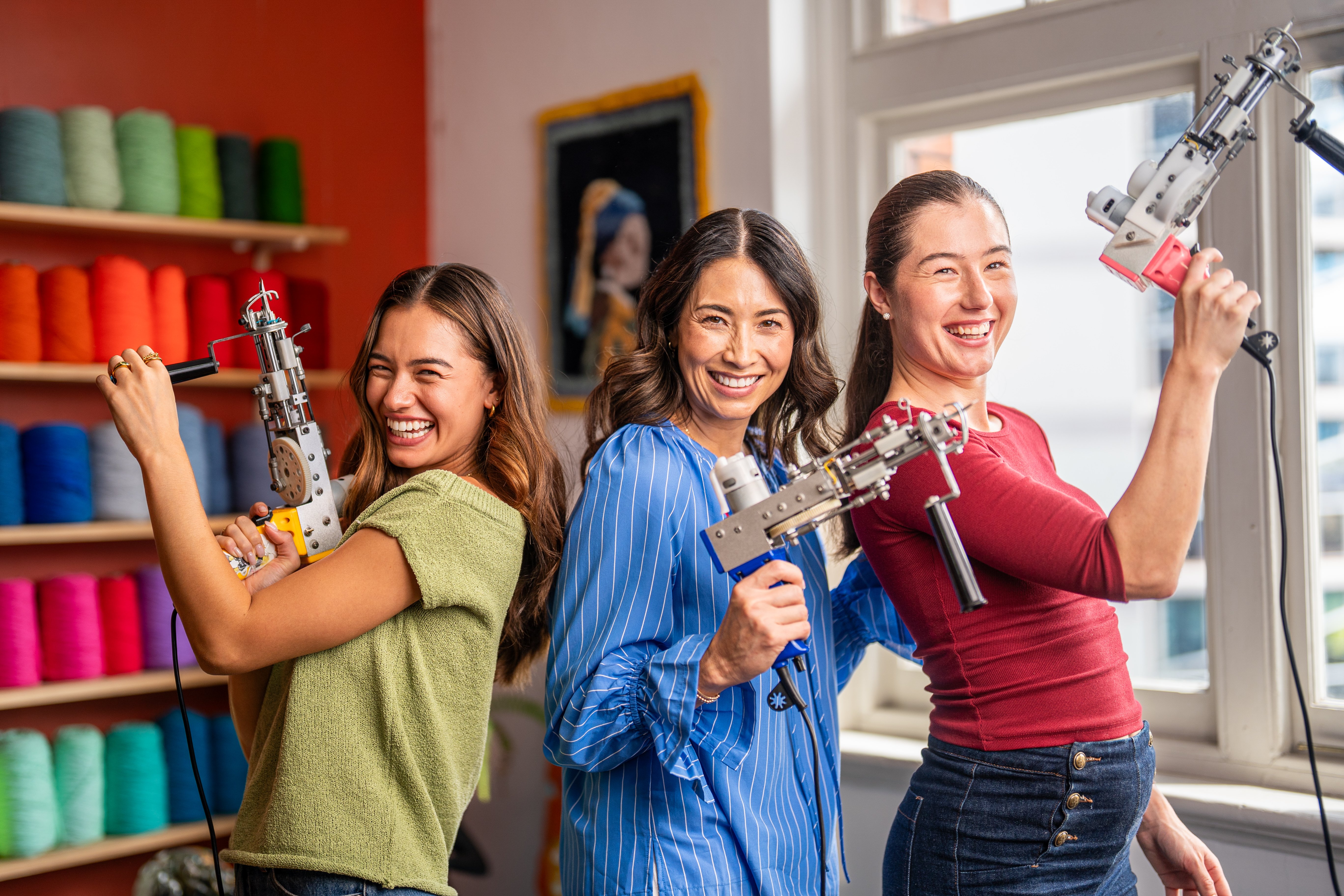Group of women holding a tufting gun 
