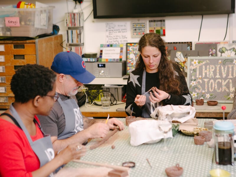 People hand building clay