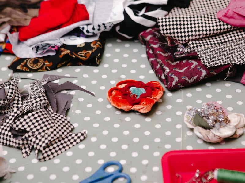 Fabrics and fabric flowers lying on the table